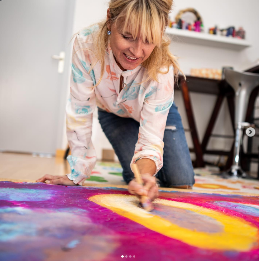 Louise painting on the studio floor