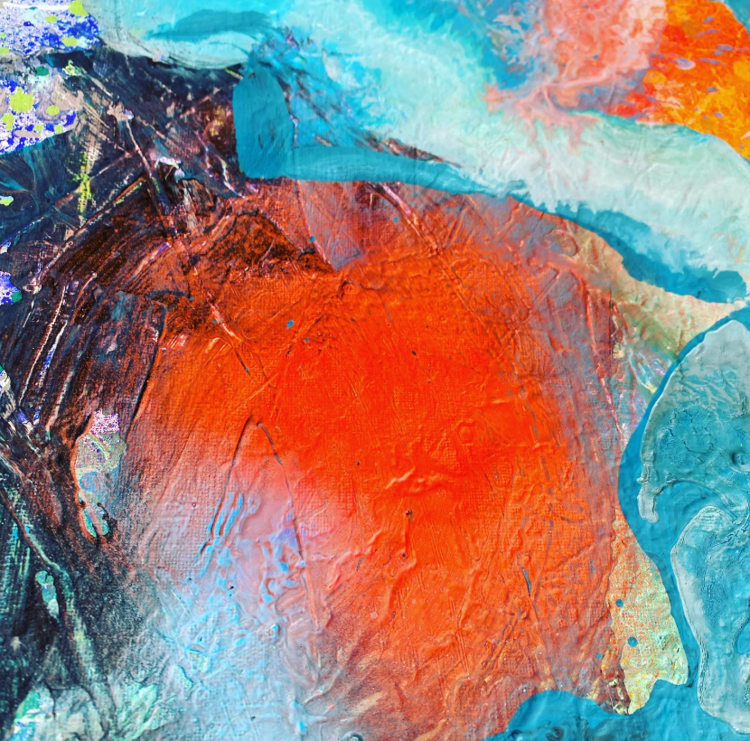 Close-up of thickly layered acrylic paint in vivid orange, turquoise and deep navy